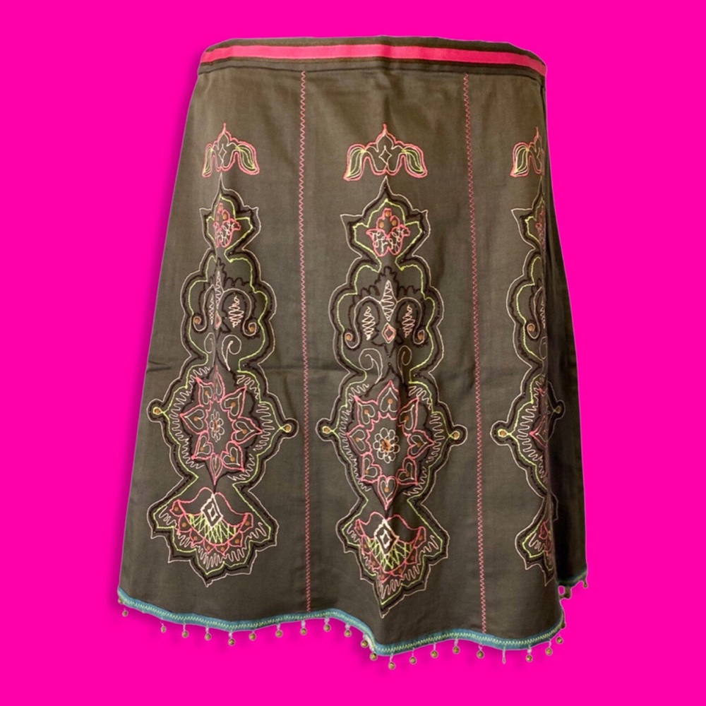 Green skirt with pink and green embroidery.